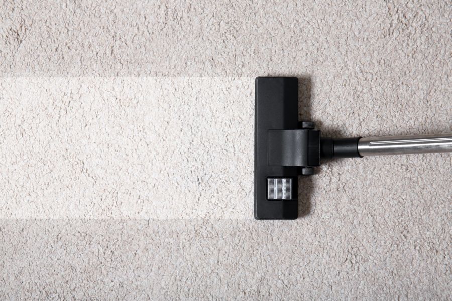 Vacuum cleaner head cleaning beige carpet